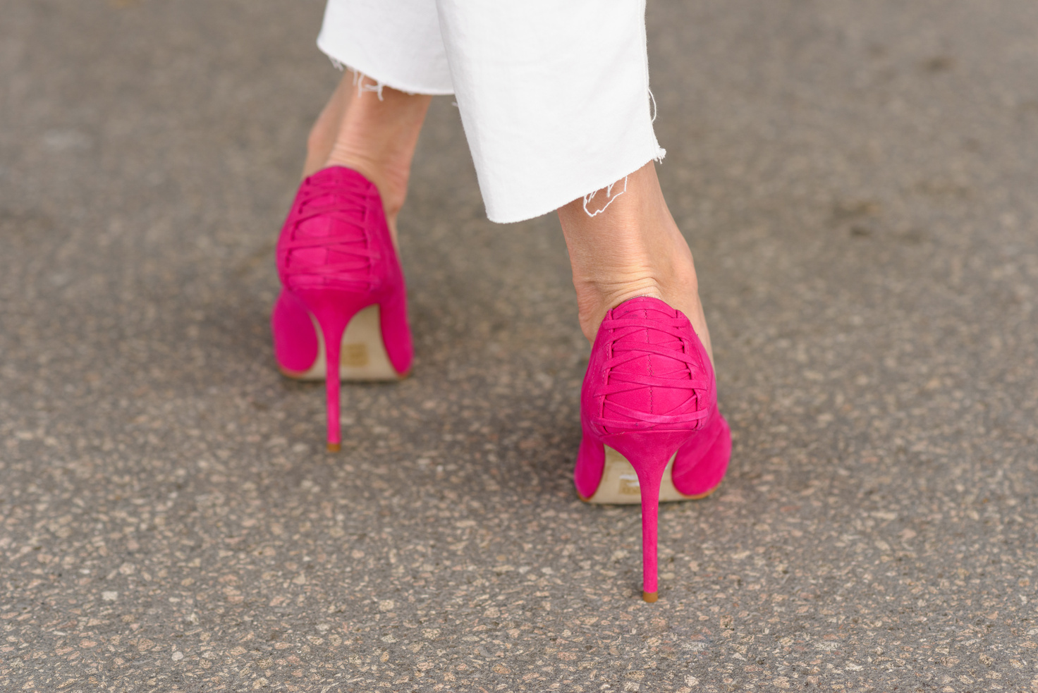Rear view of a woman wearing pink stilettos